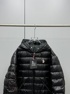 Long Moncler puffer jacket upper front detail, black with hood and zipper pull