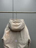 Light beige long zip-up puffer jacket back view with hood and shoulder seams