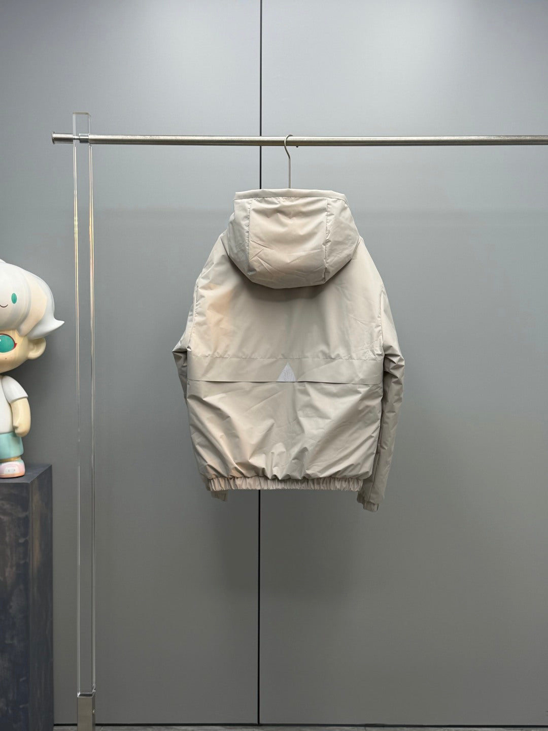 Light beige long puffer jacket back view with ribbed hem cuffs and hood