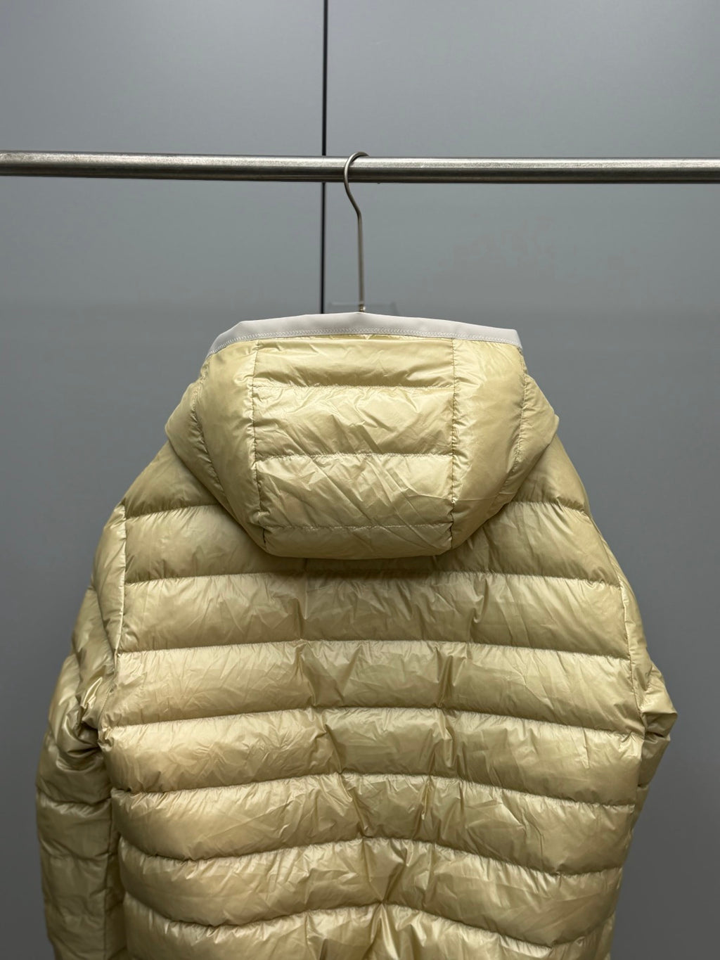 Long Moncler puffer jacket, light gold back view with hood and horizontal quilting