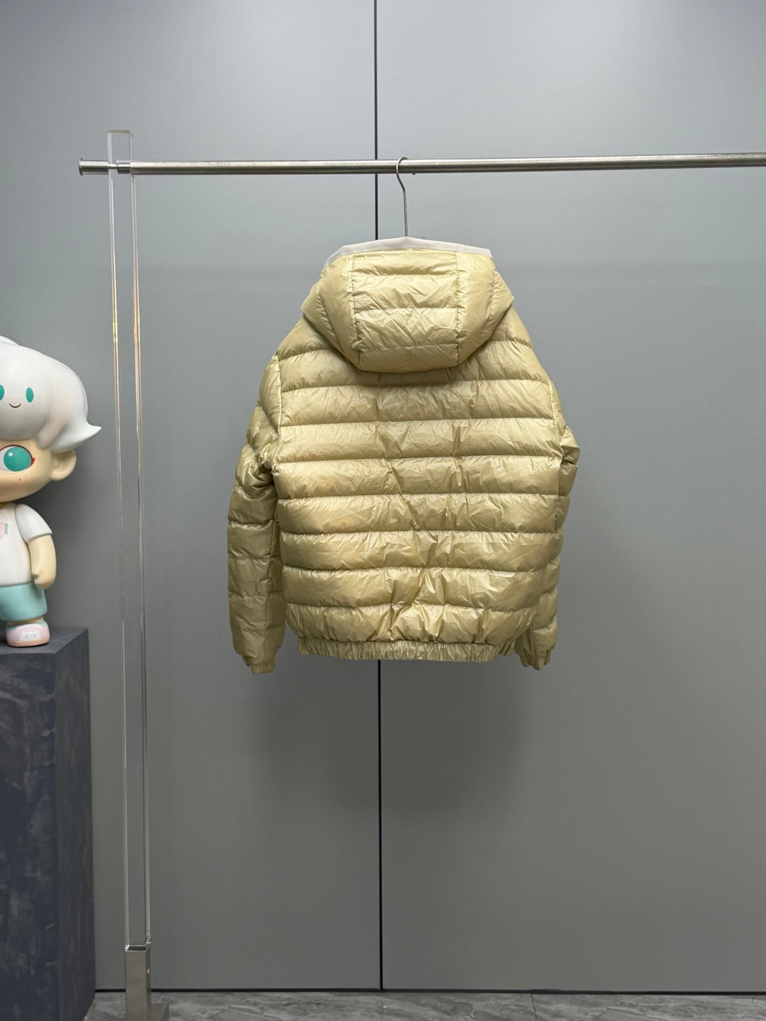 Long Moncler puffer jacket, light gold back view with full hood and quilted sleeves