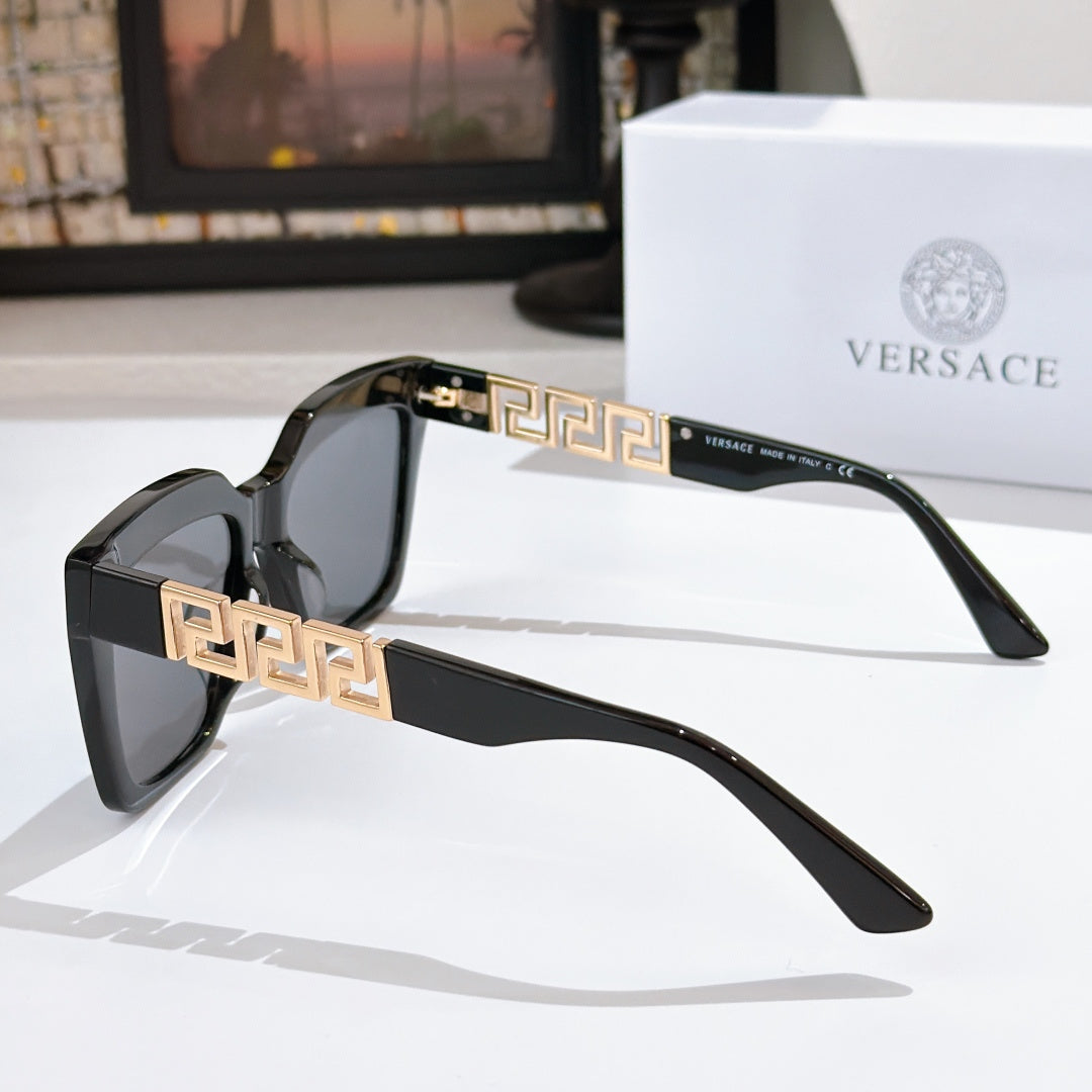 Black square sunglasses with gold temple details and dark tinted lenses, side view