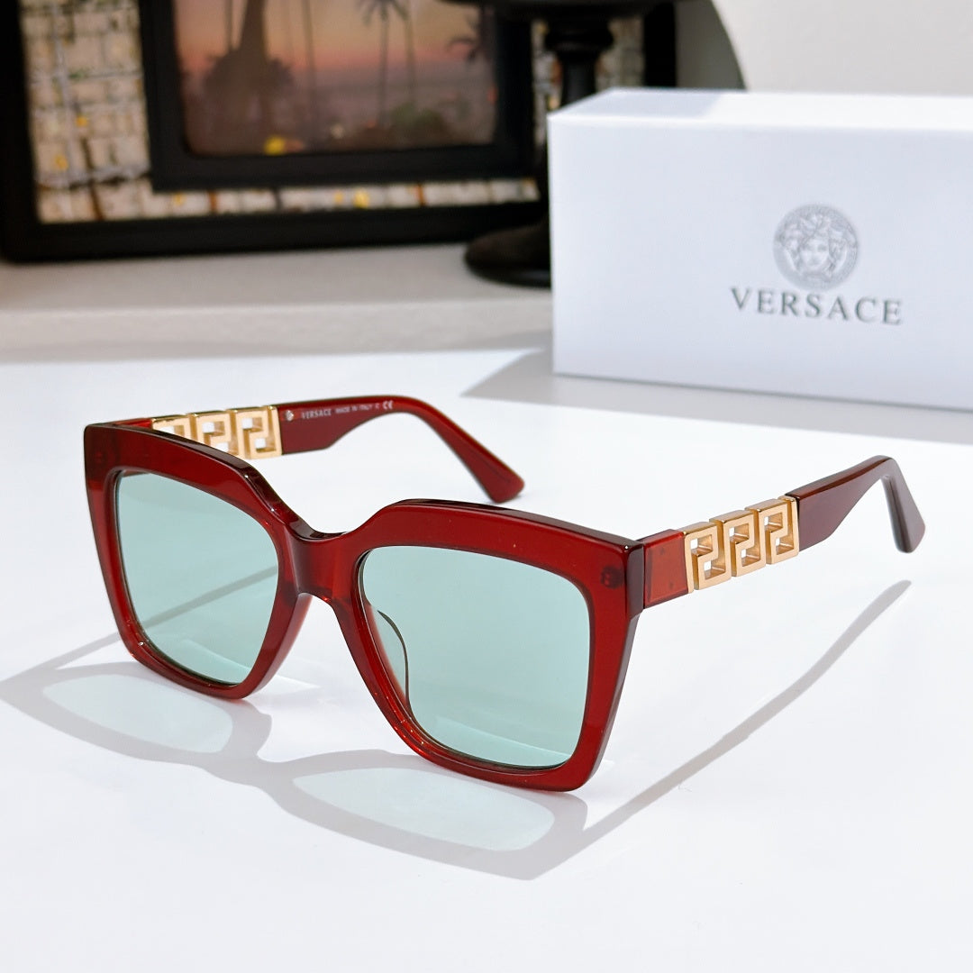 Red square sunglasses with gold temple detail and pale green tinted lenses