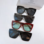Three sunglasses in mixed frames—black and red—with patterned lenses and gold accents