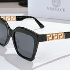 Black square sunglasses with gold Greek-key temple bar and dark lenses