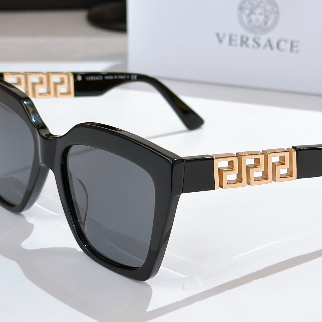 Black square sunglasses with gold Greek-key temple bar and dark lenses