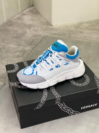 White and blue chunky lace-up sneakers with quilted side panels and logo on tongue.