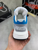 White and blue sneaker heel with blue collar lining and printed logo on back.