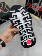 Black sneaker outsole with white geometric tread pattern and raised traction nub.