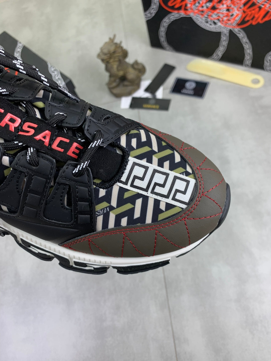 Versace sneaker upper in black with multicolor geometric panel and red stitching