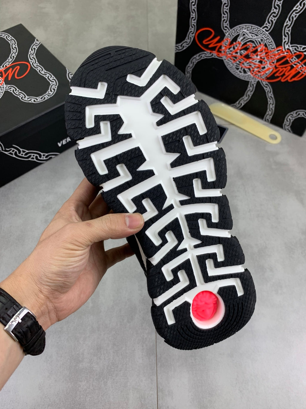 Versace sneaker outsole with white geometric traction pattern on black rubber