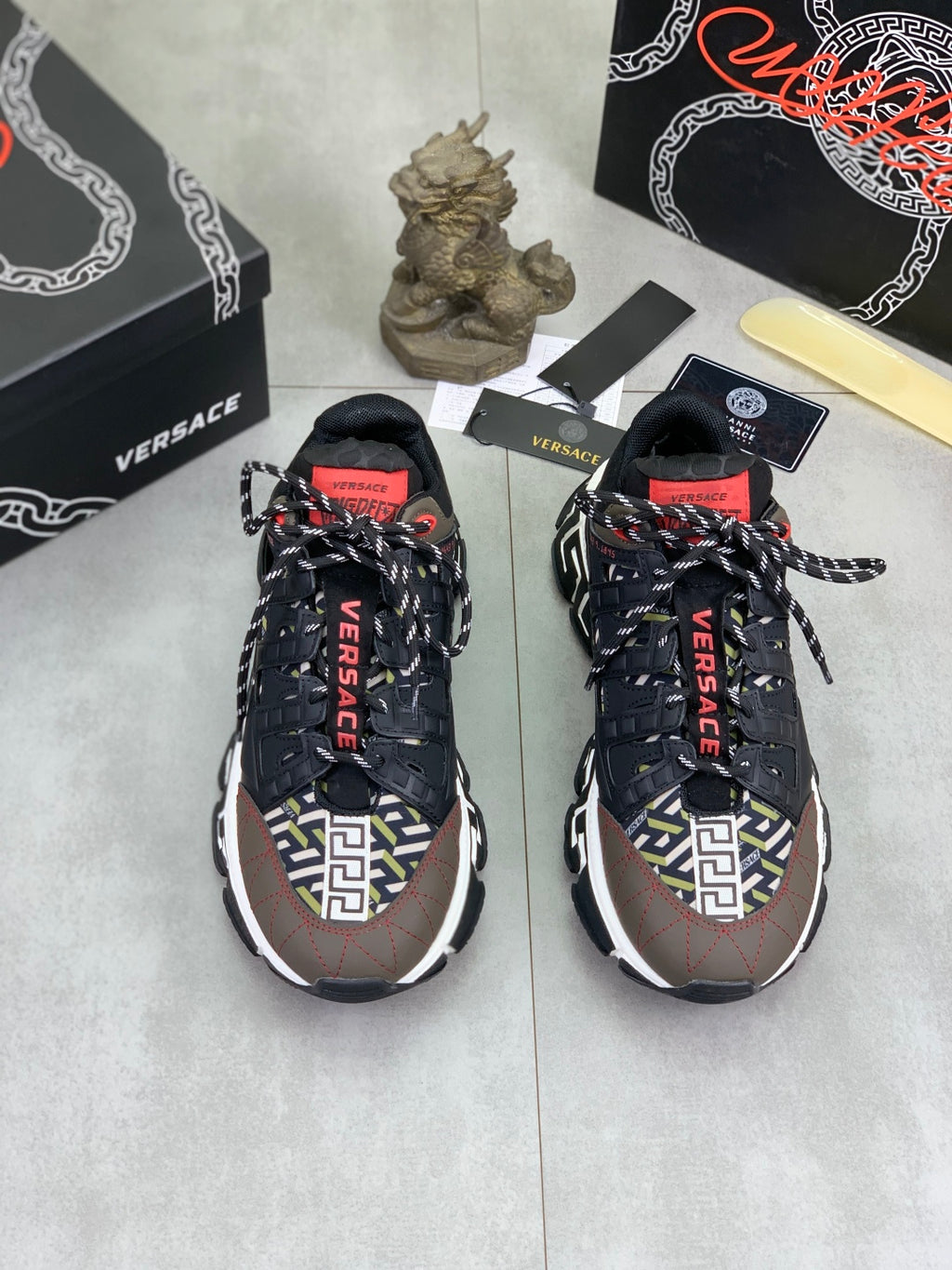 Pair of Versace lace-up sneakers in black with white logo trim and red details