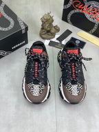 Pair of Versace lace-up sneakers in black with white logo trim and red details