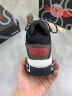 Versace sneaker heel in black with red “TRIEDIFY” graphic and white ribbed sole