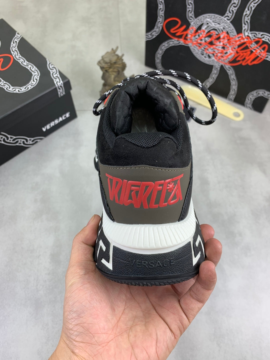 Versace sneaker heel in black with red “TRIEDIFY” graphic and white ribbed sole