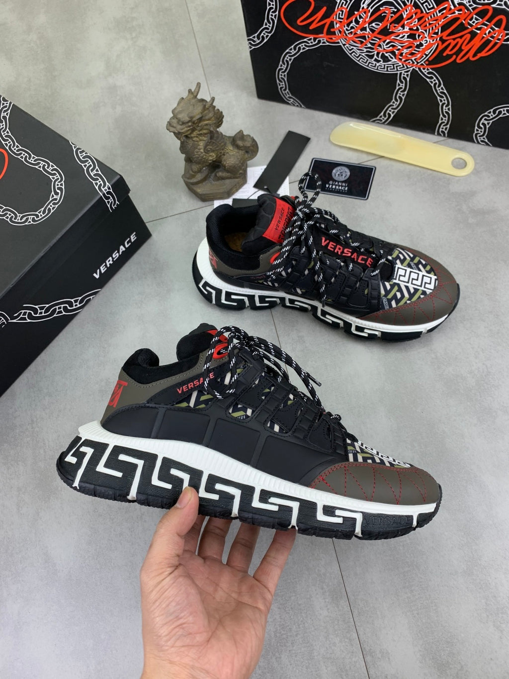 Versace sneakers in black with white Greek key sole trim and red lace tab