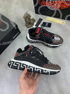 Versace sneakers in black with white Greek key sole trim and red lace tab