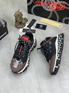 Versace lace-up sneakers in black with white Greek key side panels and red accents