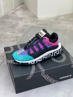 Versace sneakers on box, black and turquoise with purple panels, neon pink stripe accents