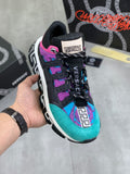 Versace sneakers with turquoise, purple, and black panels, neon pink accents, chunky sole