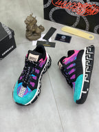 Versace sneakers side view, turquoise and purple upper with black laces and patterned sole