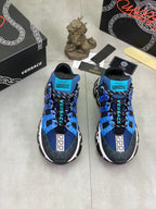 Pair of blue and black Versace sneakers with Velcro straps and white Greek key panels