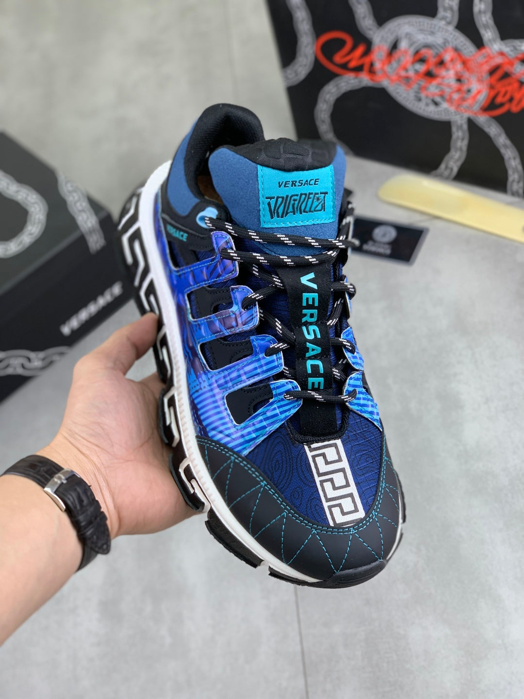 Blue and black Versace sneakers with hook-and-loop straps and white Greek key trim