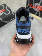 Versace sneakers heel view with blue collar, black upper, and white molded sole