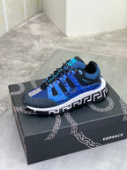 Blue Versace sneakers on a box, with white midsole and bold Greek key side emblem