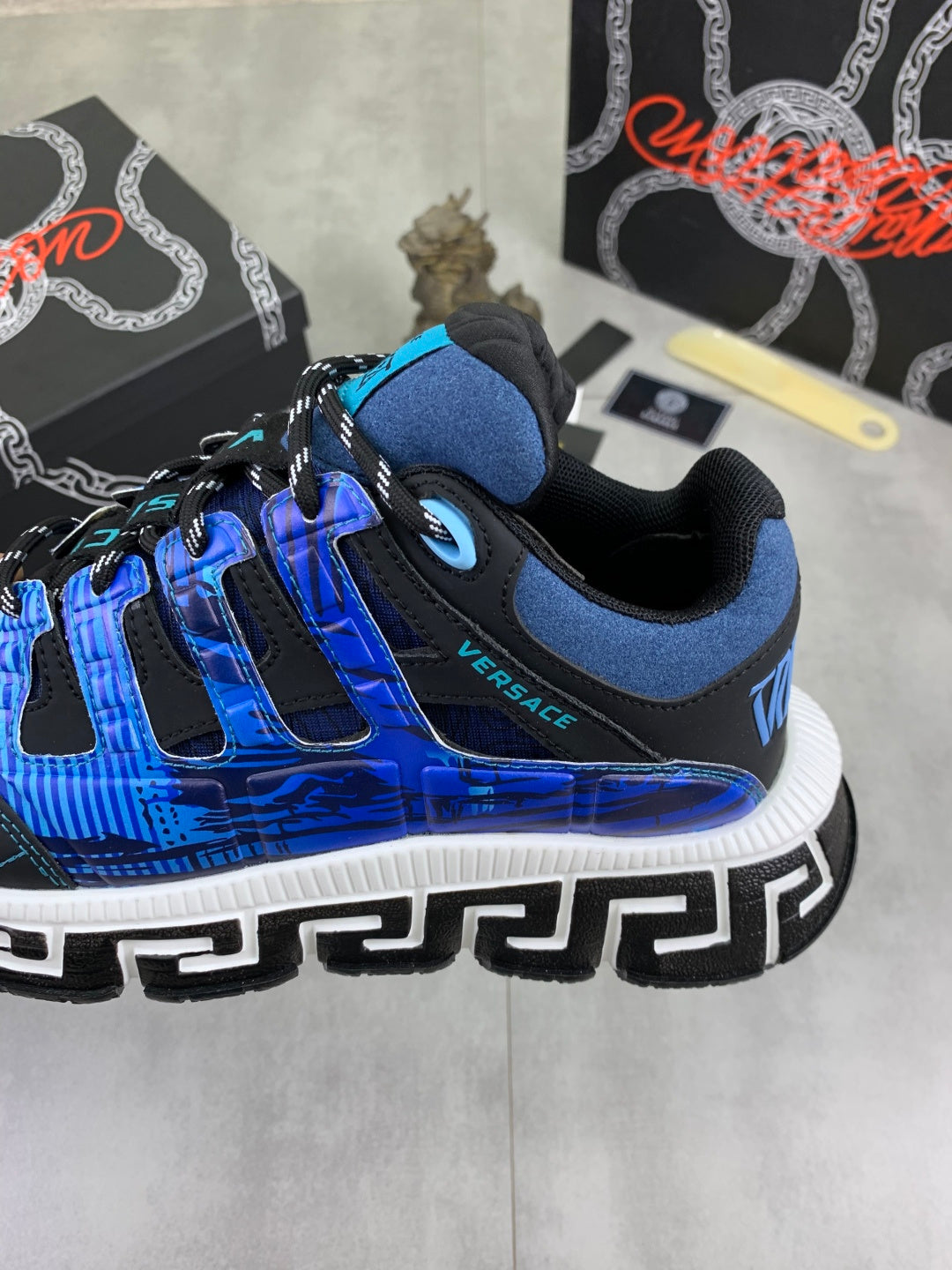 Blue and black Versace sneakers heel and side detail with white Greek key sole trim