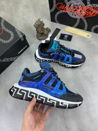 Blue and black Versace sneakers with white sole, shown from front and side