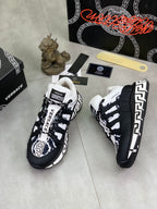 Black and white sneakers with white laces and Greca-style side trim, front view