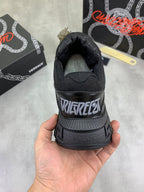 Versace luxury sneaker heel, black with VERSACE logo on treaded sole