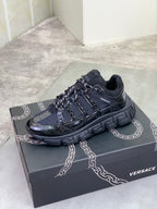 Versace luxury sneakers on box, black with blue-toned panels and lace-up straps