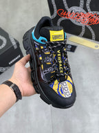 Versace black sneaker with blue and yellow patterned panels, lace-up front