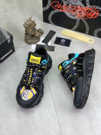 Versace black sneakers with blue accents and yellow patterned logo panel on side