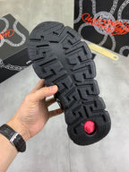 Versace black rubber outsole with deep tread pattern, sneaker bottom