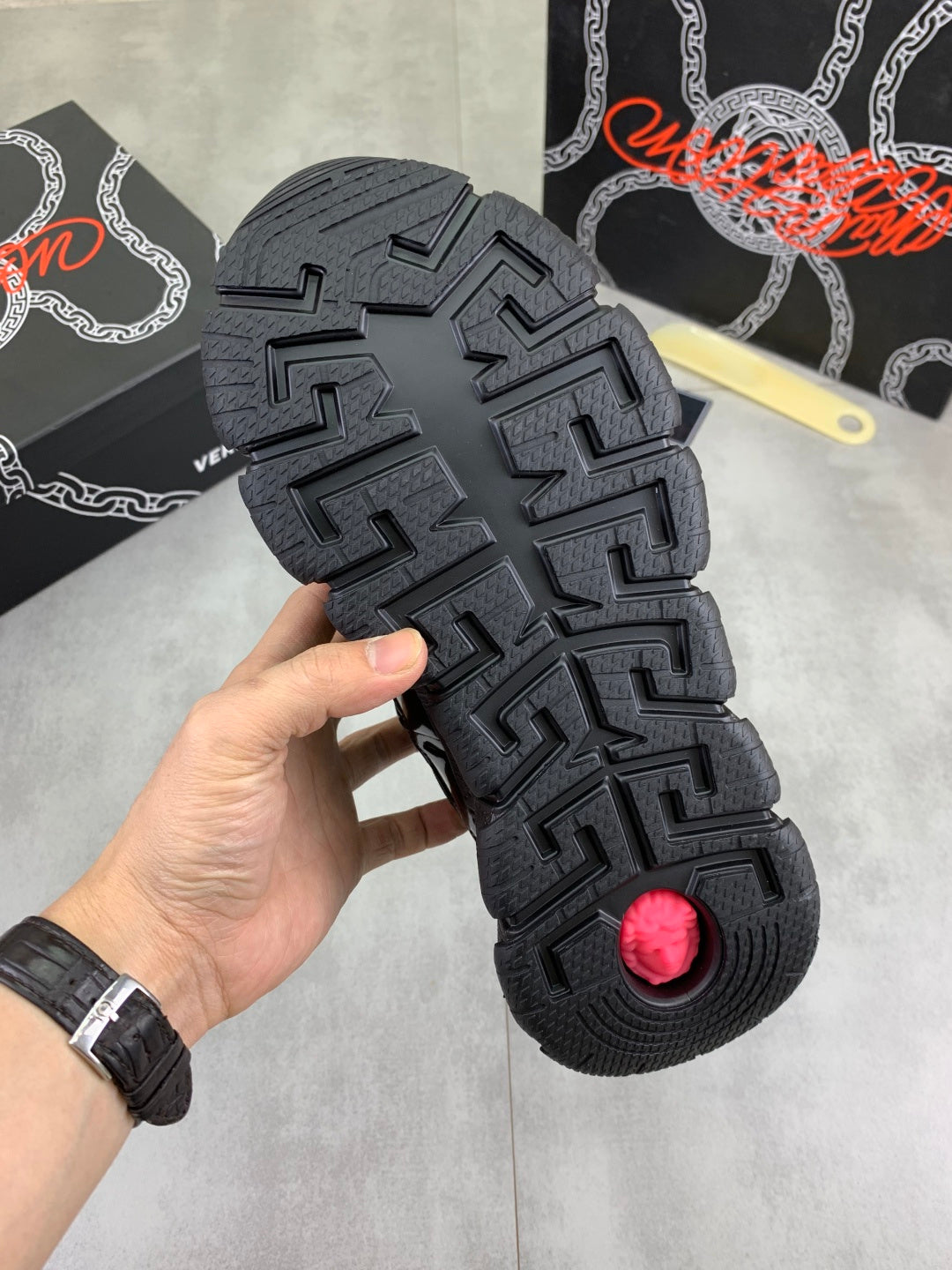 Versace black rubber outsole with deep tread pattern, sneaker bottom