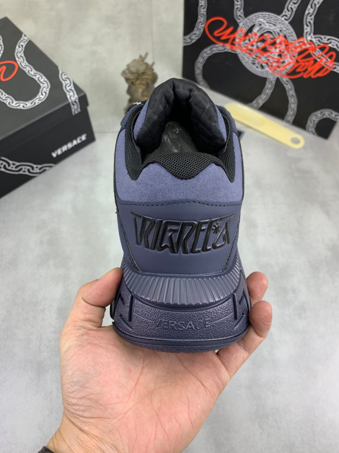 Versace luxury sneakers heel, dark navy back with embossed lettering on sole