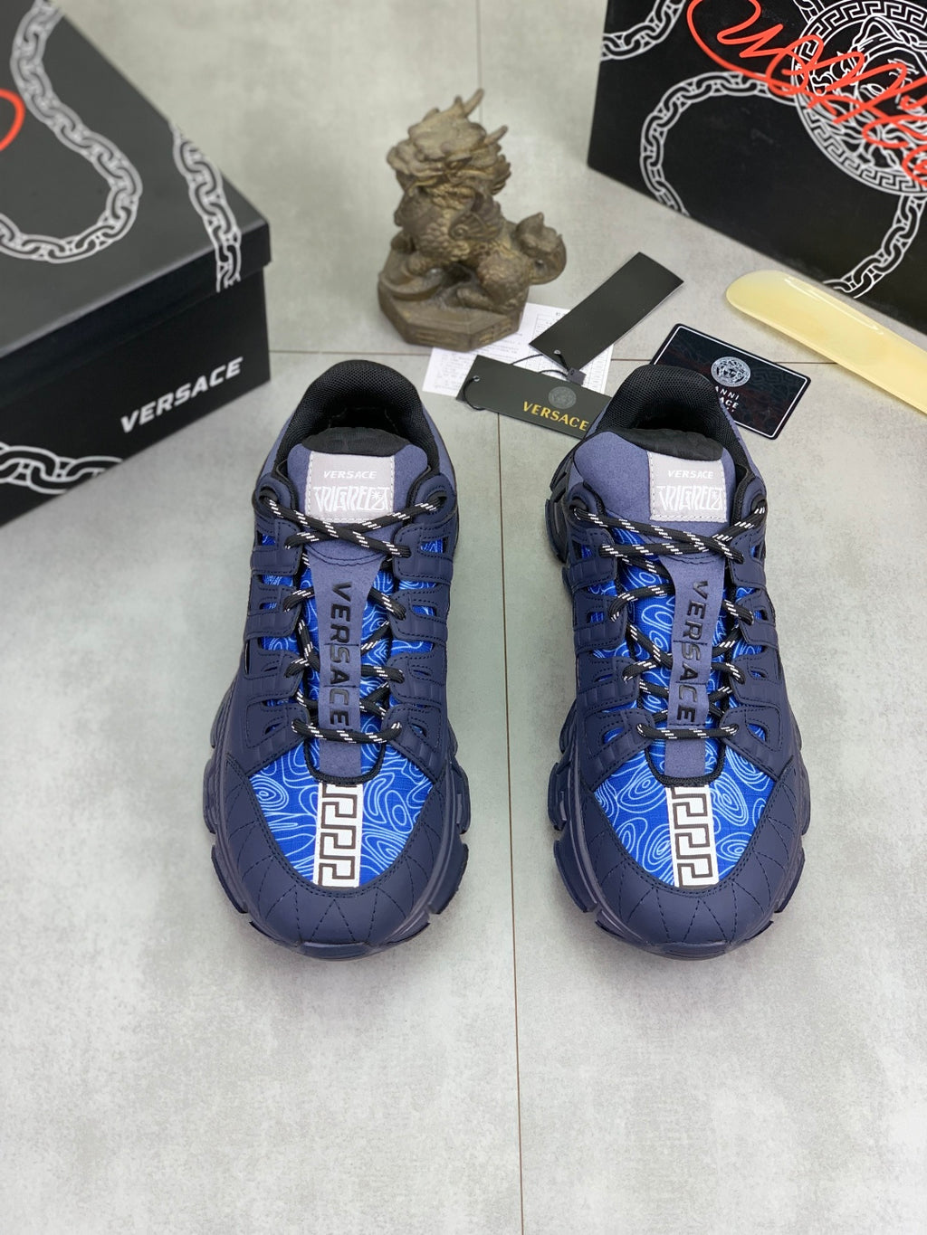 Versace blue lace-up sneakers, side by side, with contrast blue patterned panels