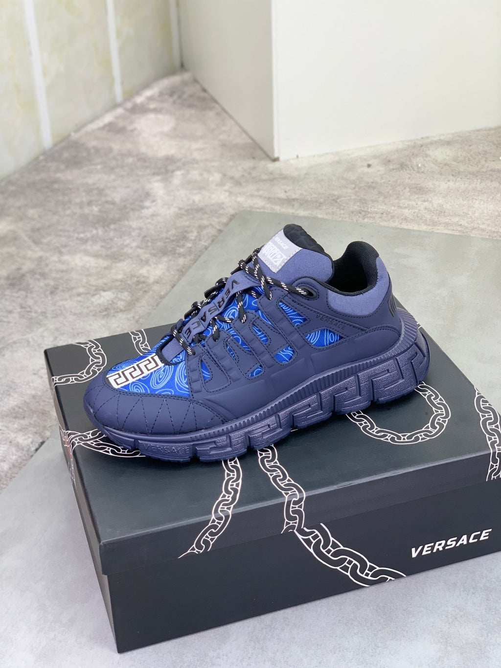 Versace blue lace-up sneakers with black Greca trim and patterned blue upper