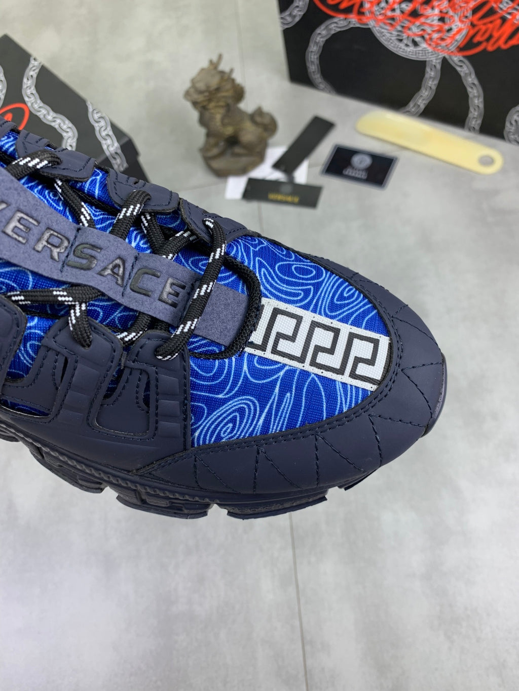 Versace luxury sneakers close-up, dark navy toe with blue patterned side panel
