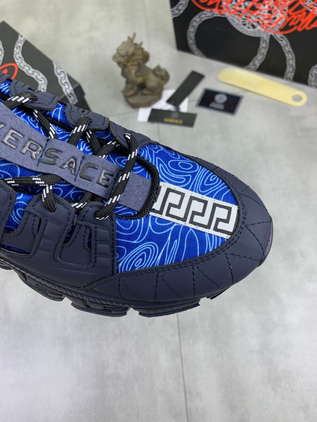 Versace blue lace-up sneaker toe detail with contrast blue swirl panel
