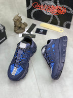 Versace blue lace-up sneakers on box, side view with Greca logo accents
