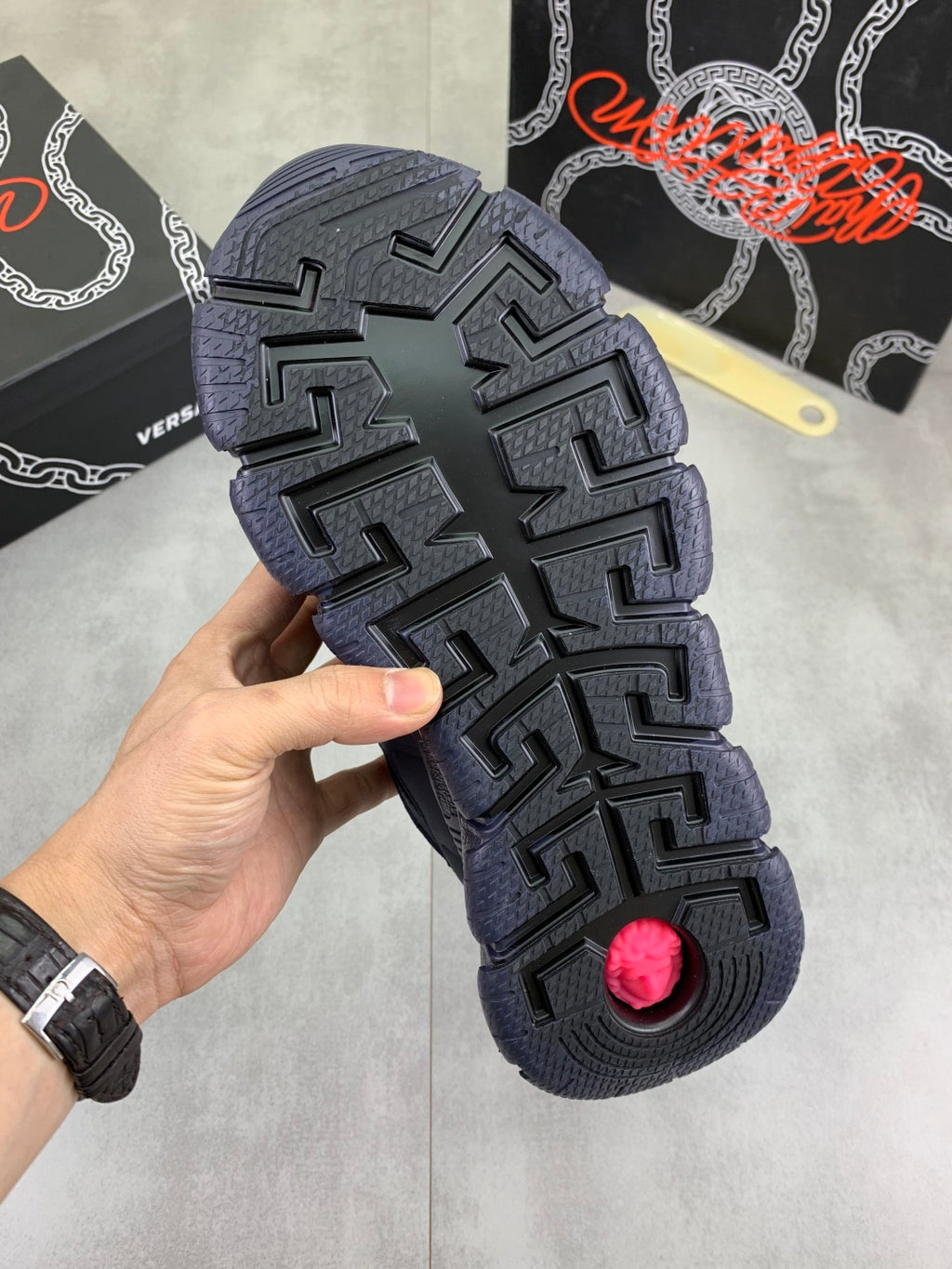 Versace blue sneaker outsole with chunky tread and red circular traction pad