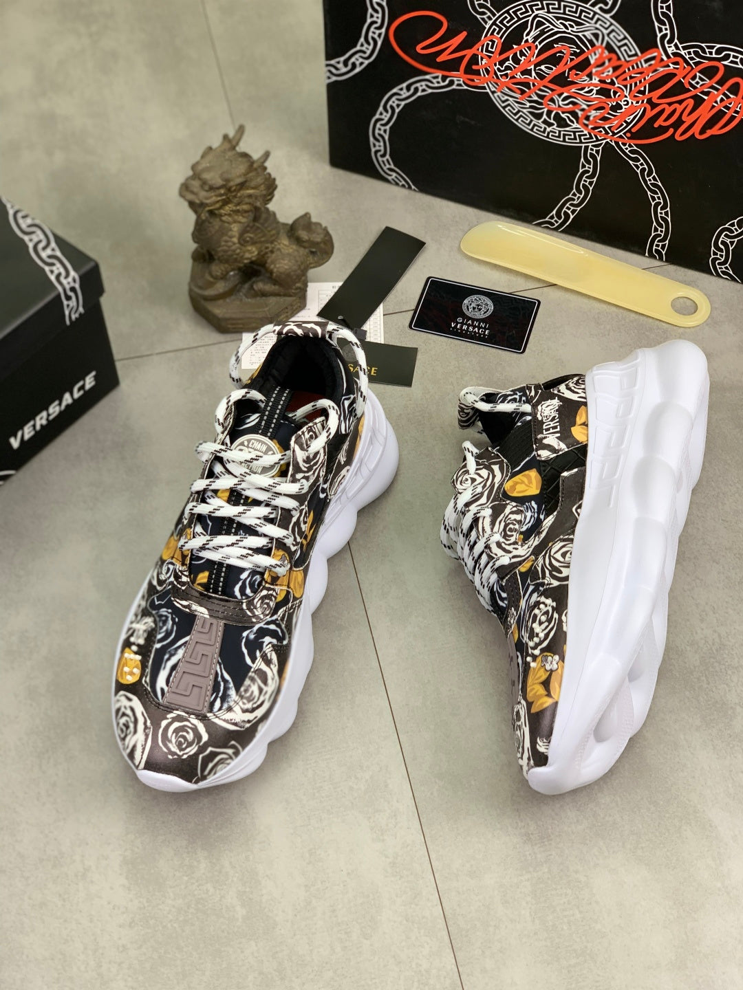 Printed sneakers with white midsoles, lace-up design, black-and-white graphic pattern and yellow details.