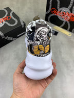 Back view of printed sneakers, black-and-white pattern with gold-yellow patch on the heel.