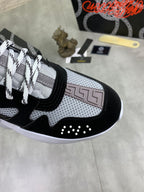 Versace sneakers side view, black and gray mesh upper with white laces and stud accents