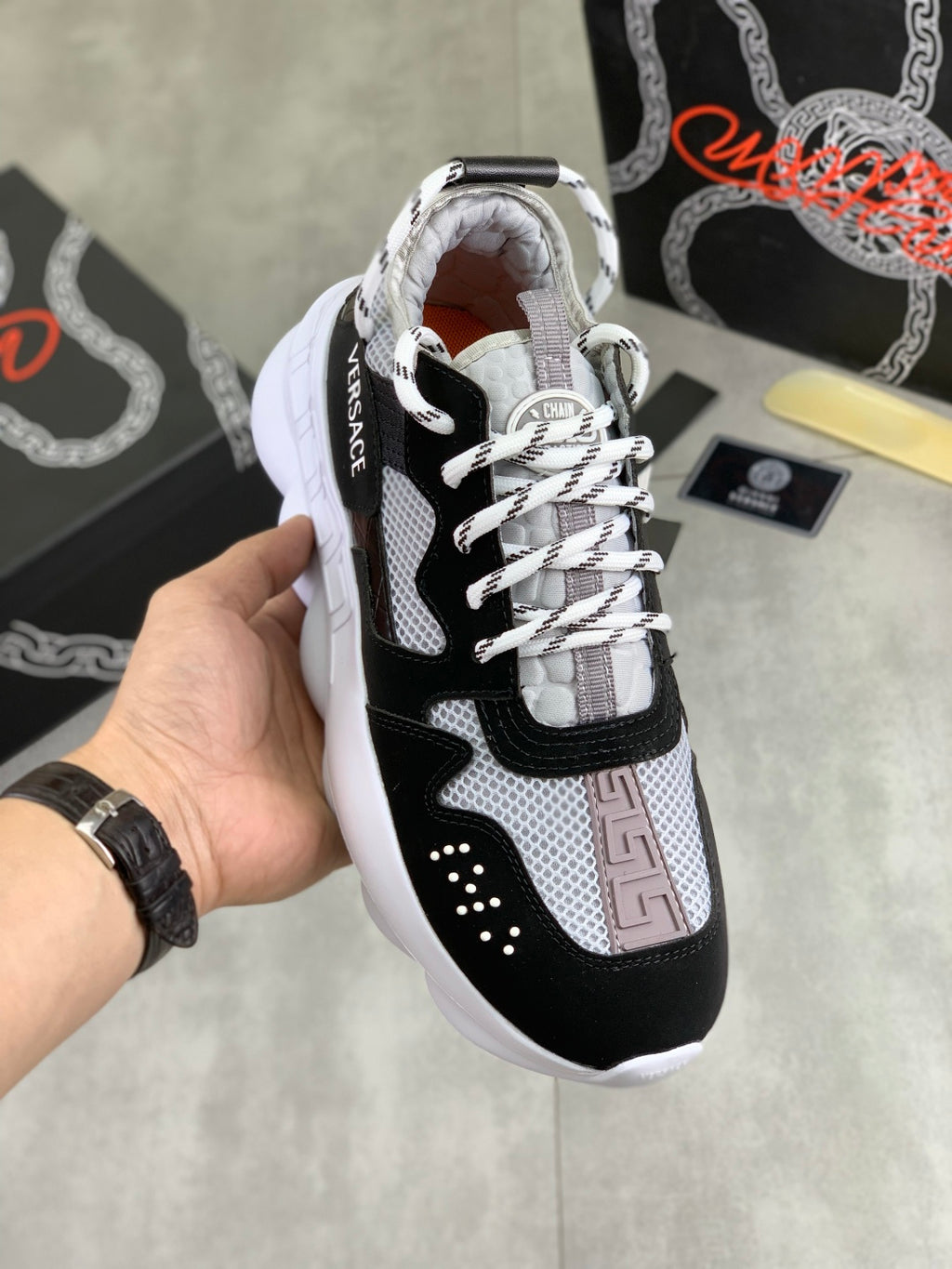 Black and white Versace lace-up sneakers with mesh paneling and contrast trim