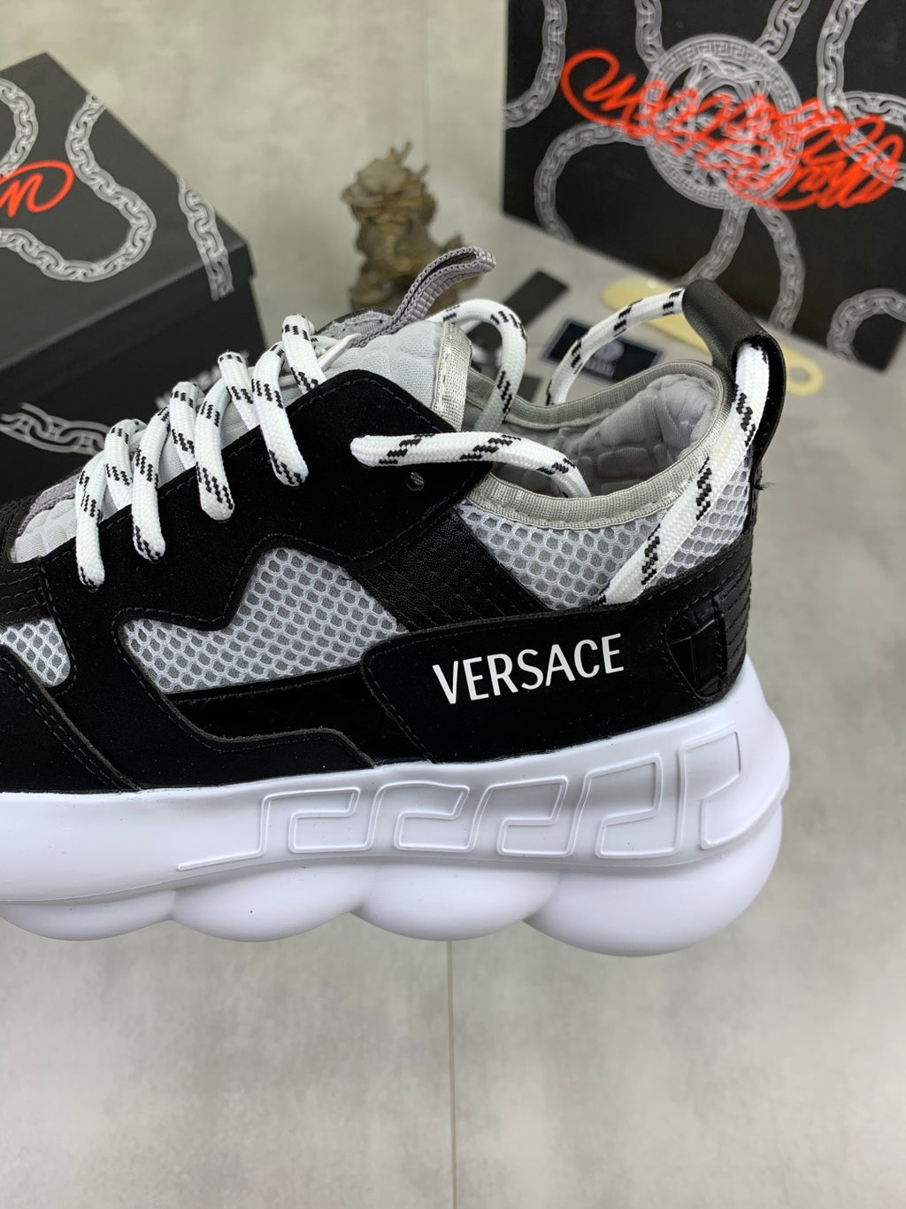 Chunky black and white Versace sneakers with white 'VERSACE' logo on the side